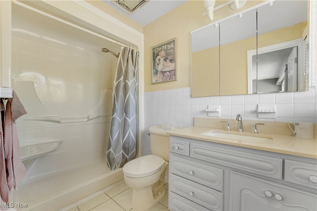 bathroom featuring vanity, tile walls, tile patterned flooring, curtained shower, and toilet