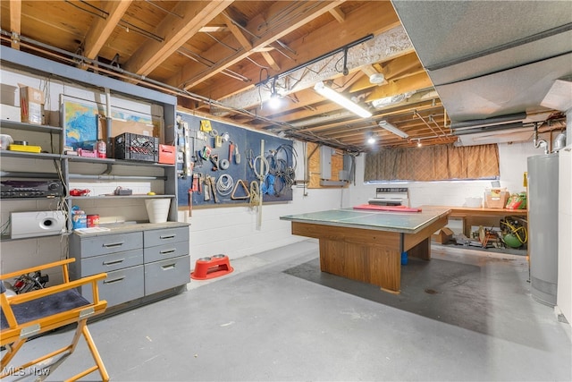 basement featuring electric panel, water heater, and a workshop area