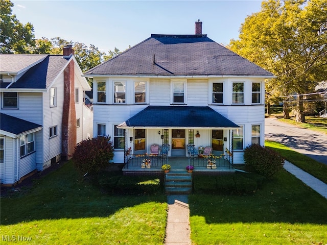 view of front of house featuring covered porch and a front yard