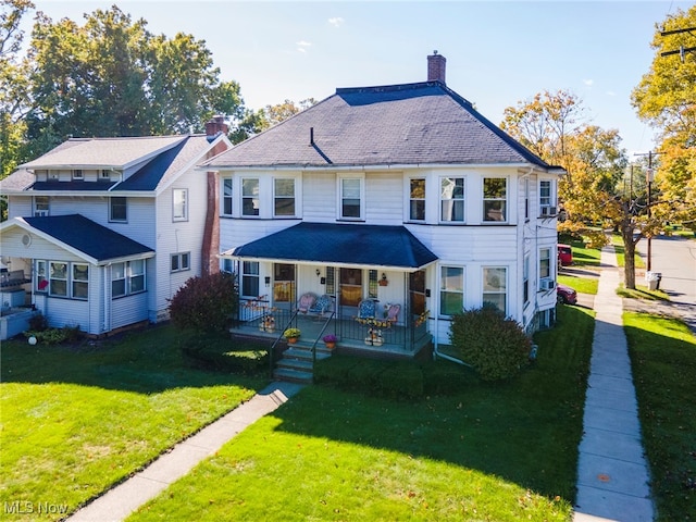 view of front of property featuring covered porch and a front yard