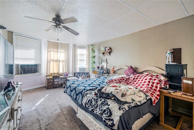 bedroom featuring ceiling fan, cooling unit, carpet flooring, and multiple windows