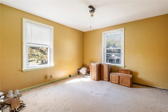 spare room featuring carpet floors and plenty of natural light