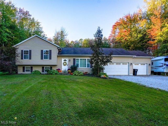 split level home featuring a garage and a front lawn