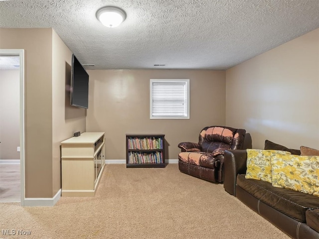 interior space featuring a textured ceiling and carpet flooring