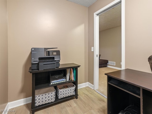 office space featuring wood-type flooring and a textured ceiling