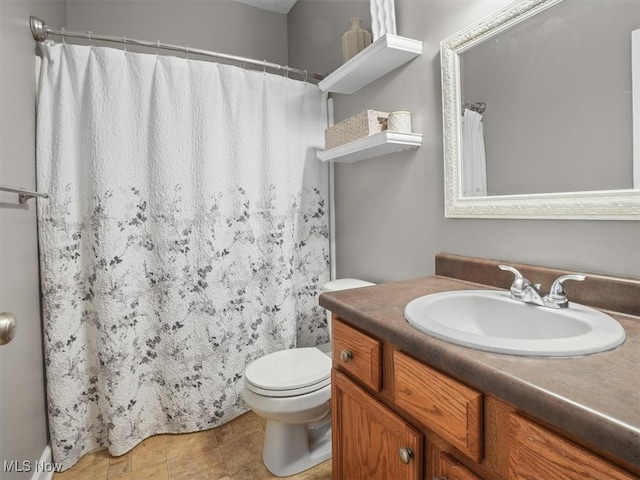 bathroom with vanity, toilet, and curtained shower