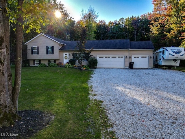 split level home with a front yard and a garage