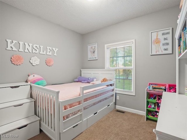 carpeted bedroom with a textured ceiling