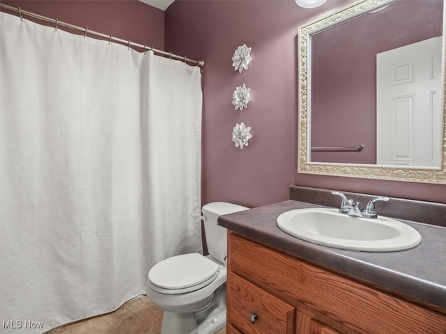 bathroom featuring tile patterned floors, vanity, and toilet