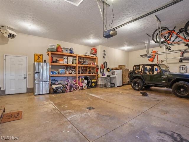 garage with stainless steel refrigerator with ice dispenser and a garage door opener