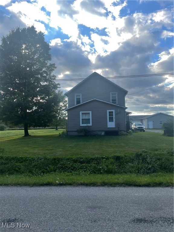 view of property exterior featuring a lawn