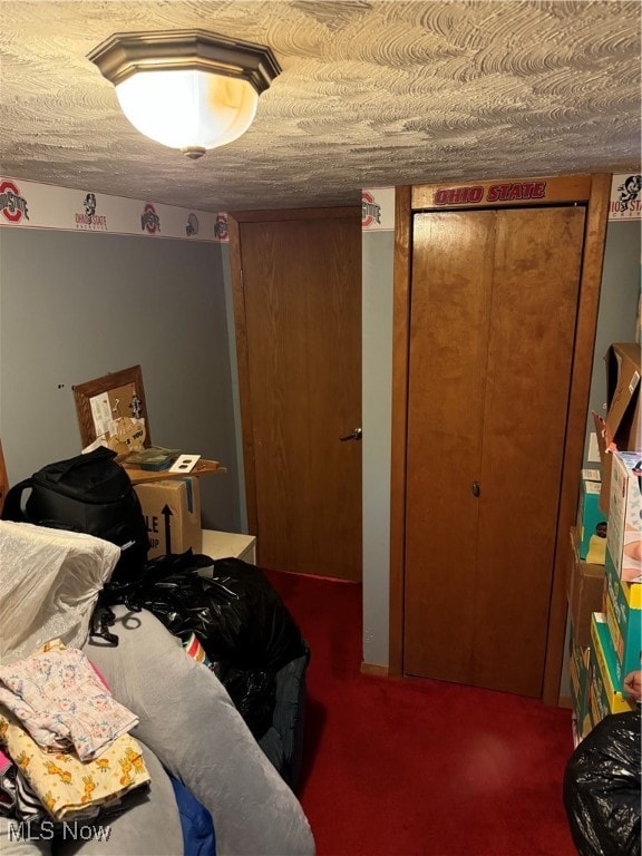 bedroom with a closet, carpet flooring, and a textured ceiling