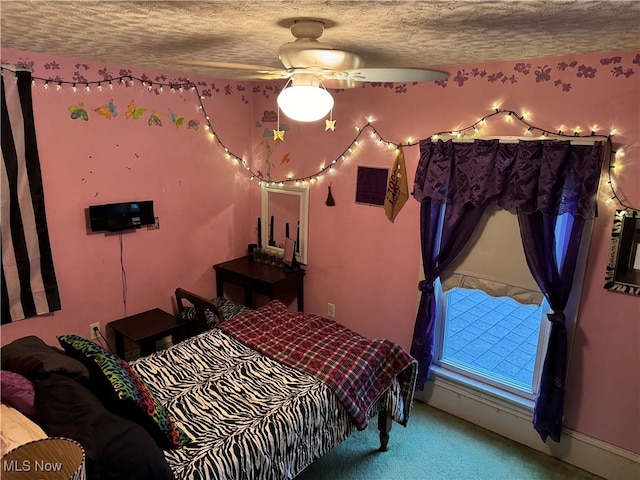 carpeted bedroom with ceiling fan and a textured ceiling