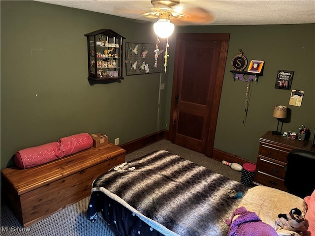 bedroom with carpet flooring, ceiling fan, and a textured ceiling