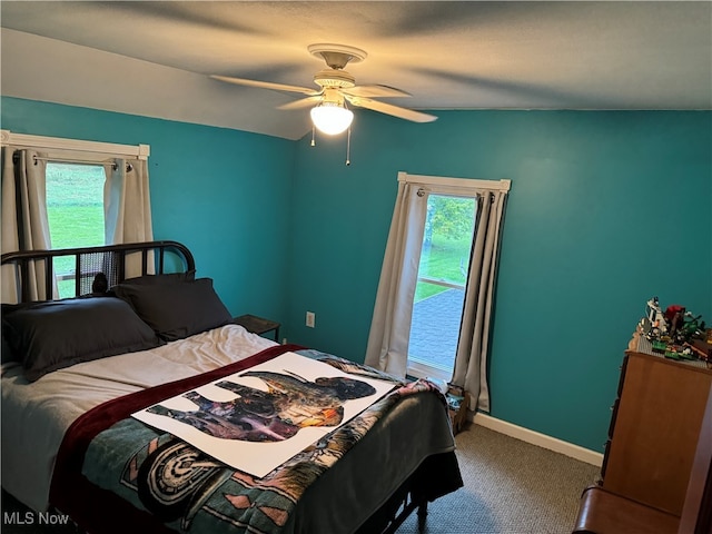 carpeted bedroom with multiple windows and ceiling fan