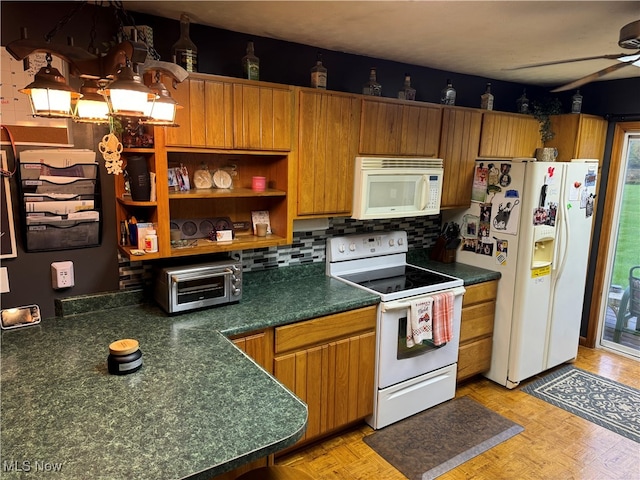 kitchen with decorative backsplash, white appliances, light parquet flooring, and a wealth of natural light