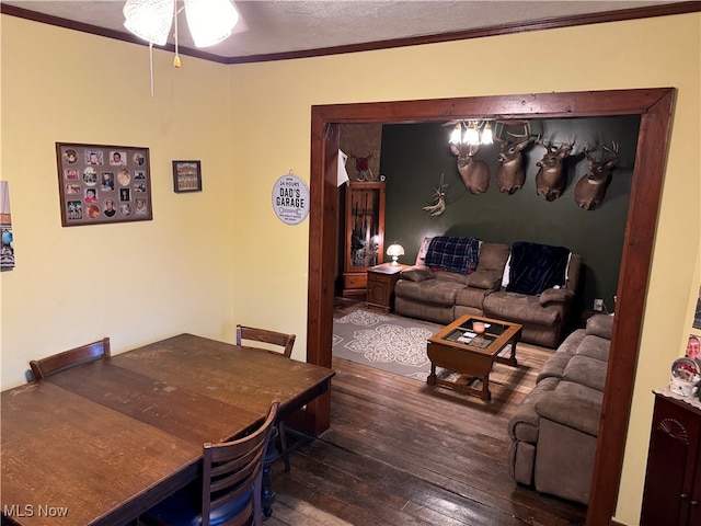 dining space with dark wood-type flooring, ceiling fan, crown molding, and a textured ceiling