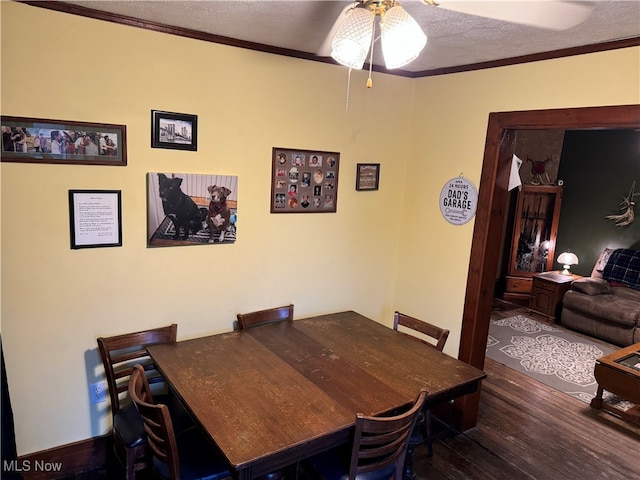 dining area featuring ornamental molding, ceiling fan, dark hardwood / wood-style floors, and a textured ceiling