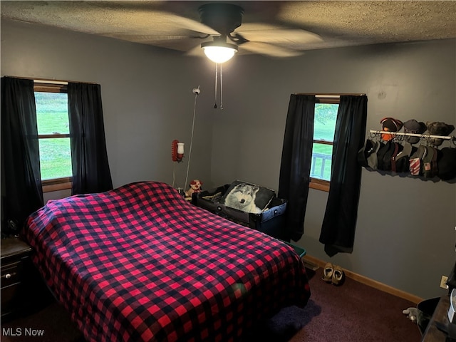 bedroom featuring carpet, a textured ceiling, and ceiling fan