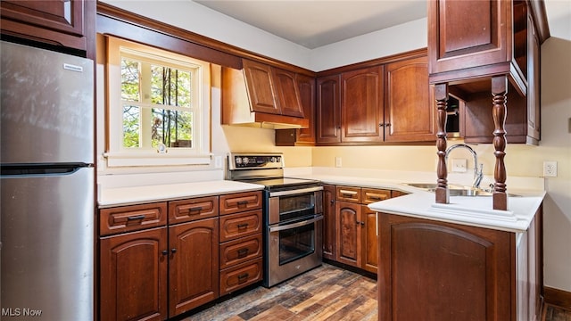 kitchen with premium range hood, sink, stainless steel appliances, and dark hardwood / wood-style flooring