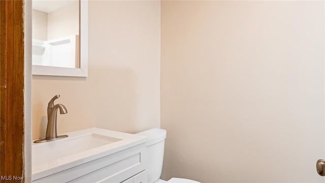 bathroom with vanity and toilet