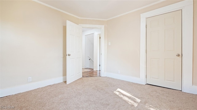 unfurnished bedroom featuring ornamental molding and light carpet