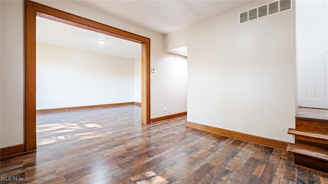 spare room with dark hardwood / wood-style flooring