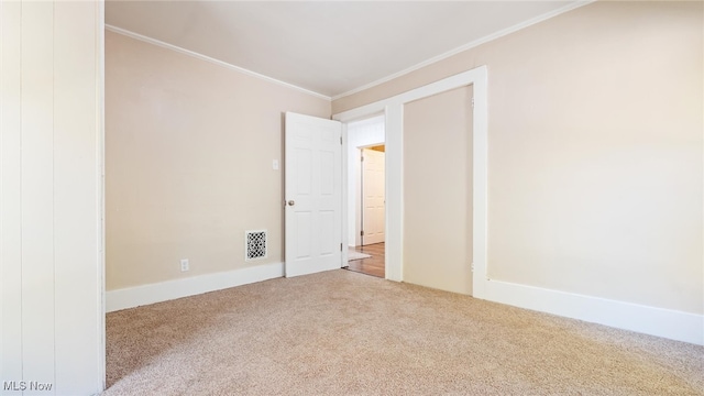 carpeted spare room with ornamental molding