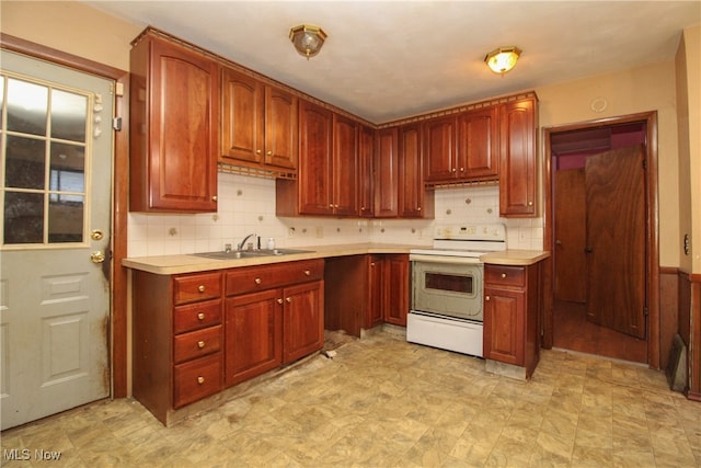 kitchen with white electric range oven, sink, and decorative backsplash