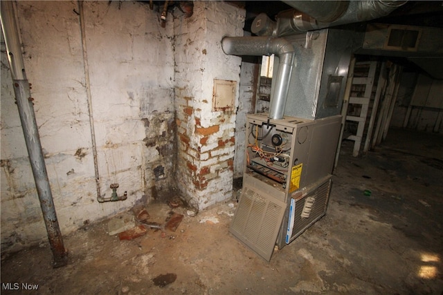 utility room featuring heating unit