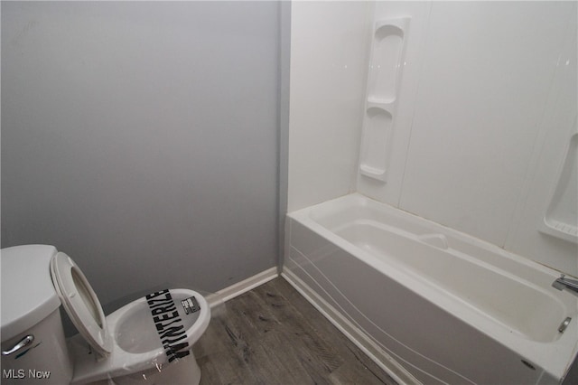 bathroom featuring hardwood / wood-style flooring and toilet