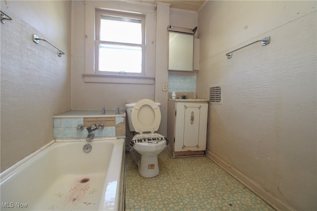 bathroom featuring sink, a washtub, and toilet