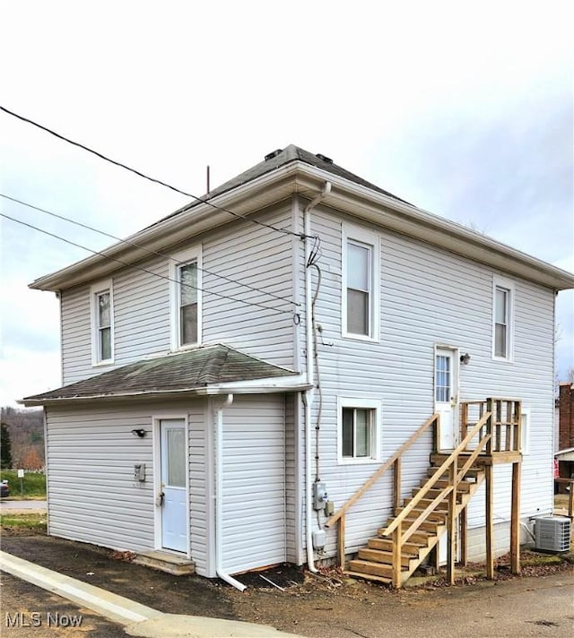 back of property featuring central air condition unit