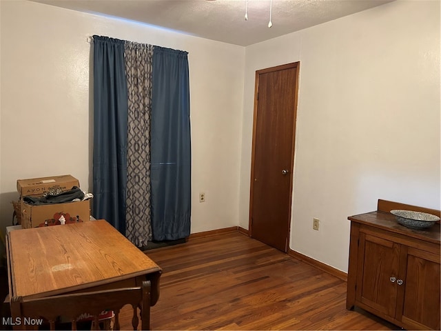 office space with dark wood-type flooring