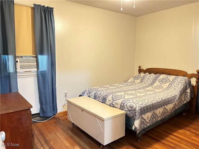 bedroom featuring dark hardwood / wood-style floors and cooling unit