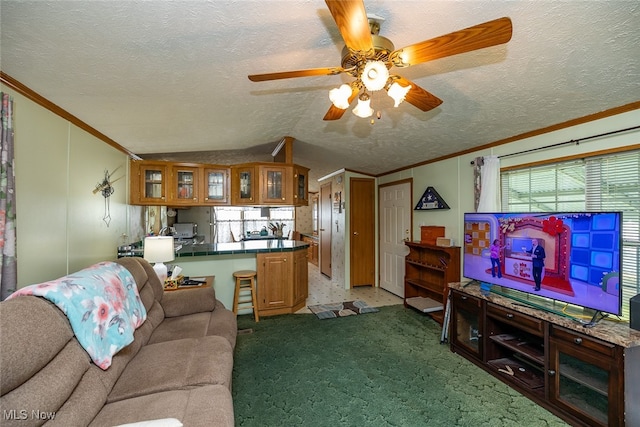 carpeted living room with ornamental molding, ceiling fan, vaulted ceiling, and a textured ceiling