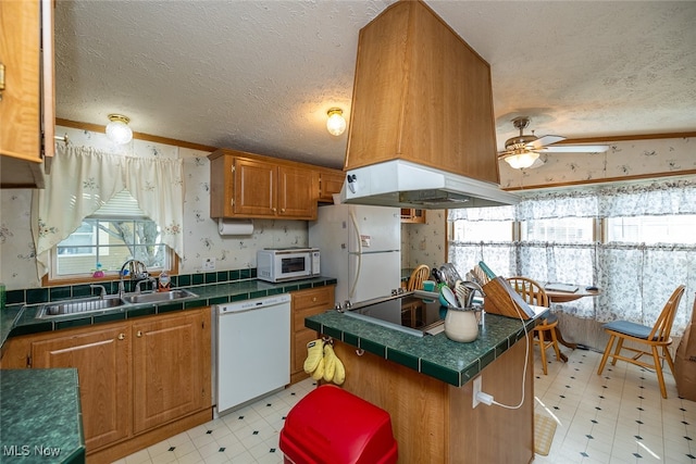 kitchen featuring a textured ceiling, sink, and white appliances