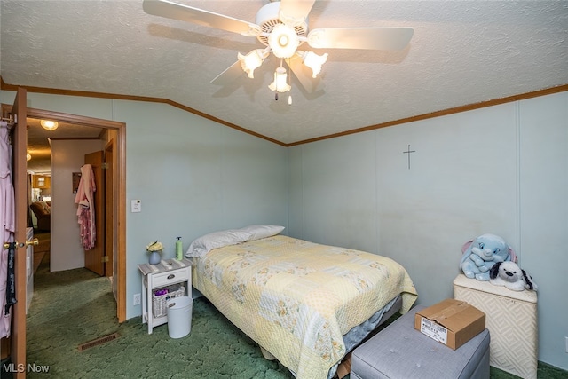 bedroom featuring lofted ceiling, ceiling fan, carpet, and a textured ceiling