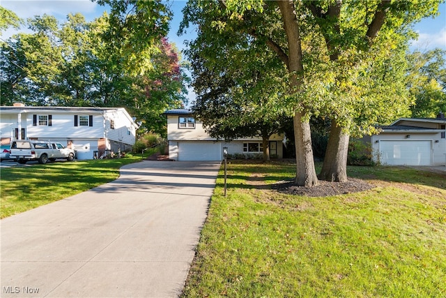 view of front of property with a garage and a front lawn