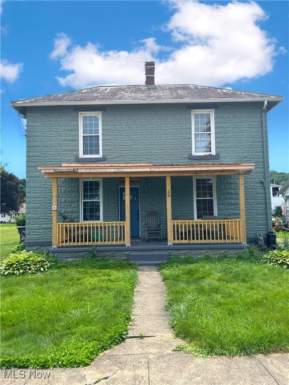 view of front of home with covered porch and a front yard