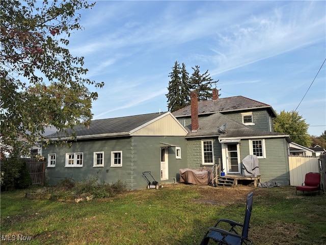 rear view of house with a lawn