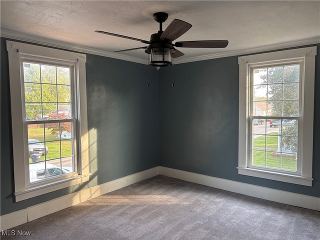 unfurnished room featuring ceiling fan, a healthy amount of sunlight, a textured ceiling, and carpet floors