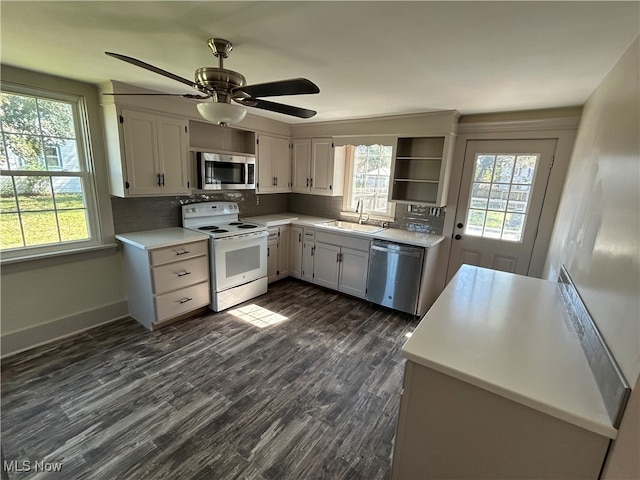 kitchen featuring tasteful backsplash, ceiling fan, dark hardwood / wood-style flooring, sink, and stainless steel appliances