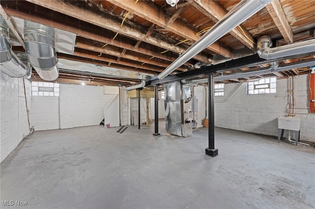 basement with heating unit and sink