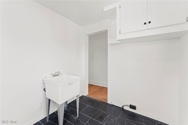 laundry area with dark hardwood / wood-style floors