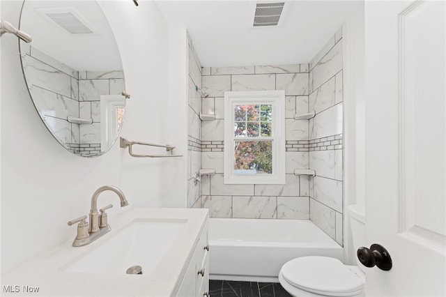 full bathroom featuring tiled shower / bath combo, vanity, and toilet