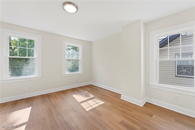 empty room featuring light hardwood / wood-style floors and a healthy amount of sunlight