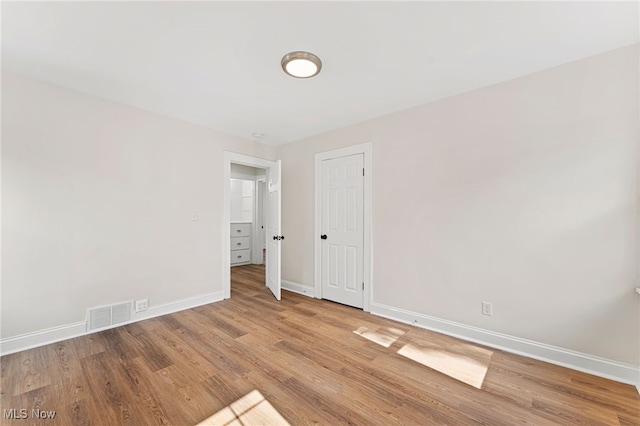 empty room with hardwood / wood-style flooring