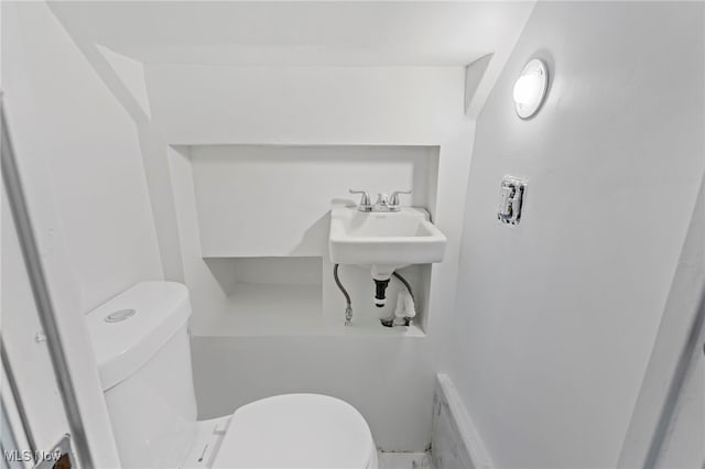 bathroom featuring sink and toilet