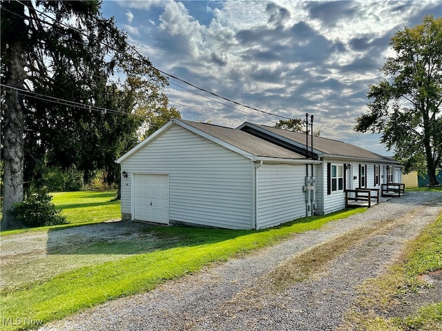 view of property exterior with a garage and a yard